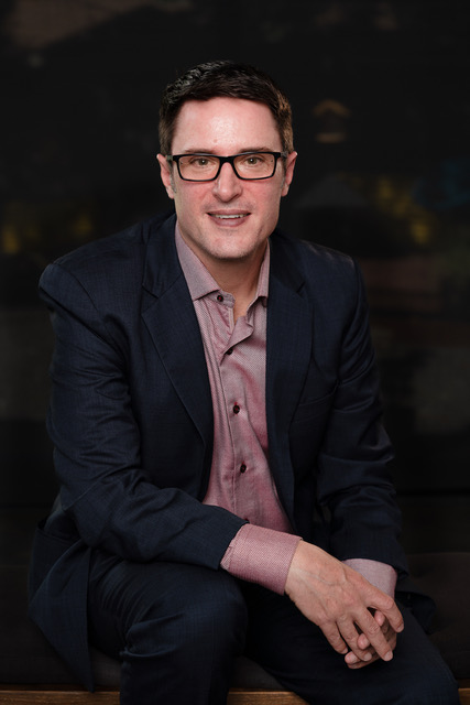 A headshot of Chad Fenner smiling at the camera