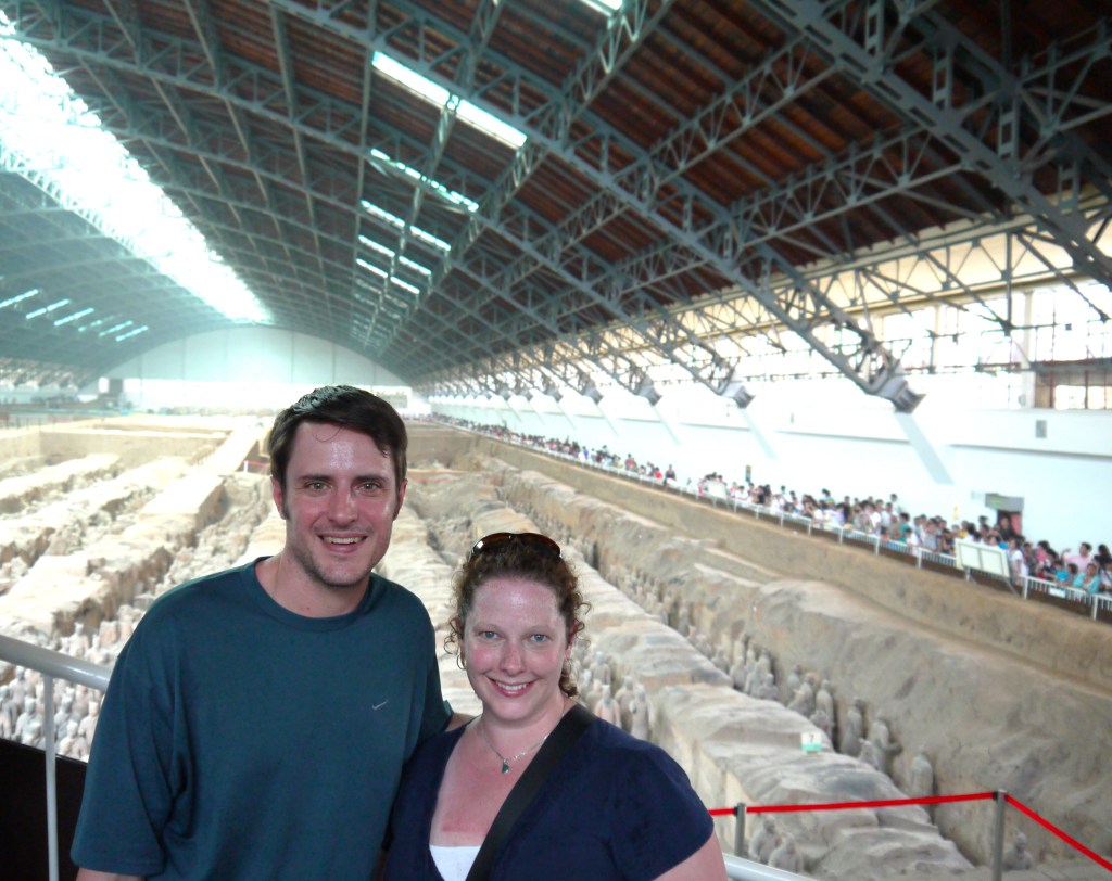 Chad Fenner and his wife posing in front of the terracotta warrior statues in China